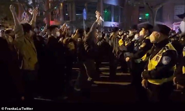 The decision was made as a result of China's strict Covid lockdowns that have led to unprecedented civil unrest across the country - with protesters clashing with police in this screen grab taken from social media