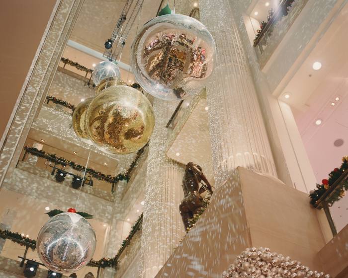 Christmas decorations hang from a store’s ceiling