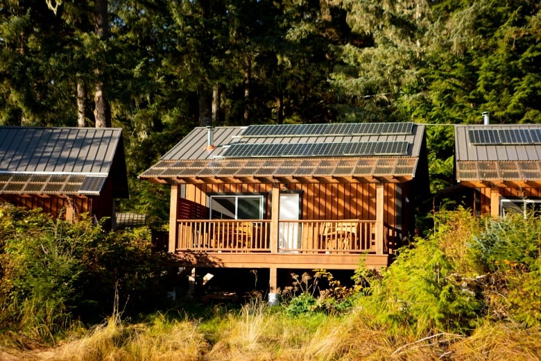 A series of small buildings with solar panels on the roof.