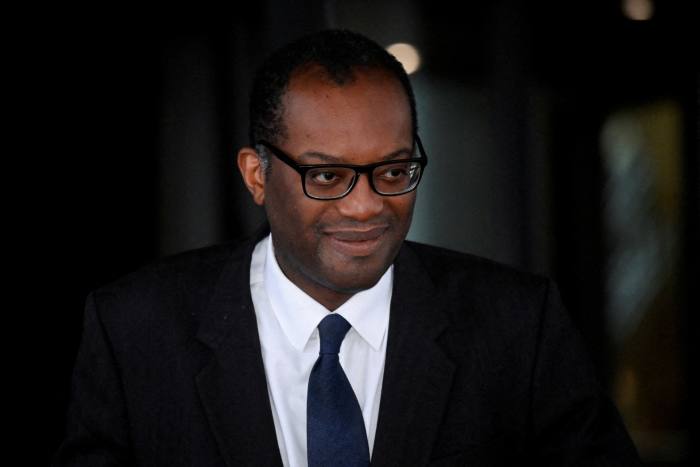 Kwasi Kwarteng walks outside a hotel in Birmingham