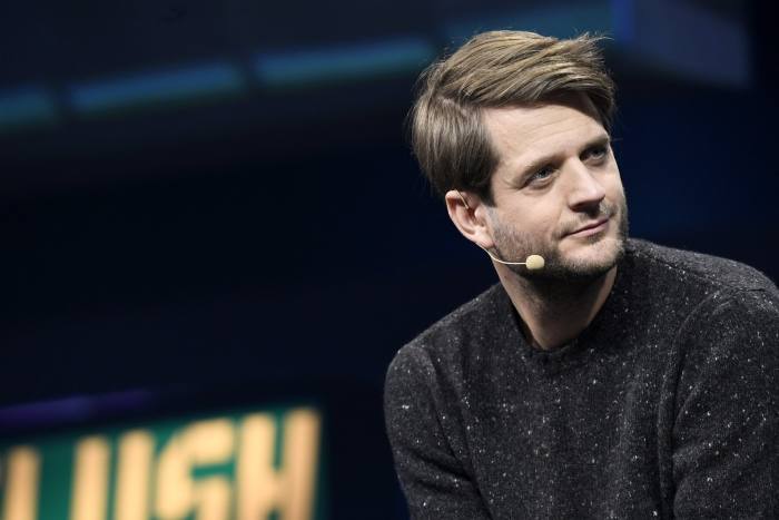 Sebastian Siemiatkowski listens on stage during an event