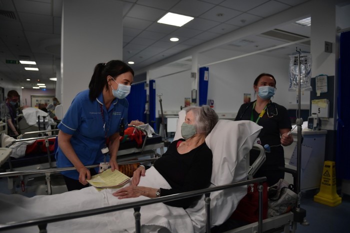 Nurse Lisa Fox attends to patient Elizabeth Huddleston at the Royal Victoria Hospital in Belfast