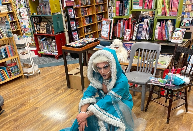 Drag Queen crouches down to talk to a toddler