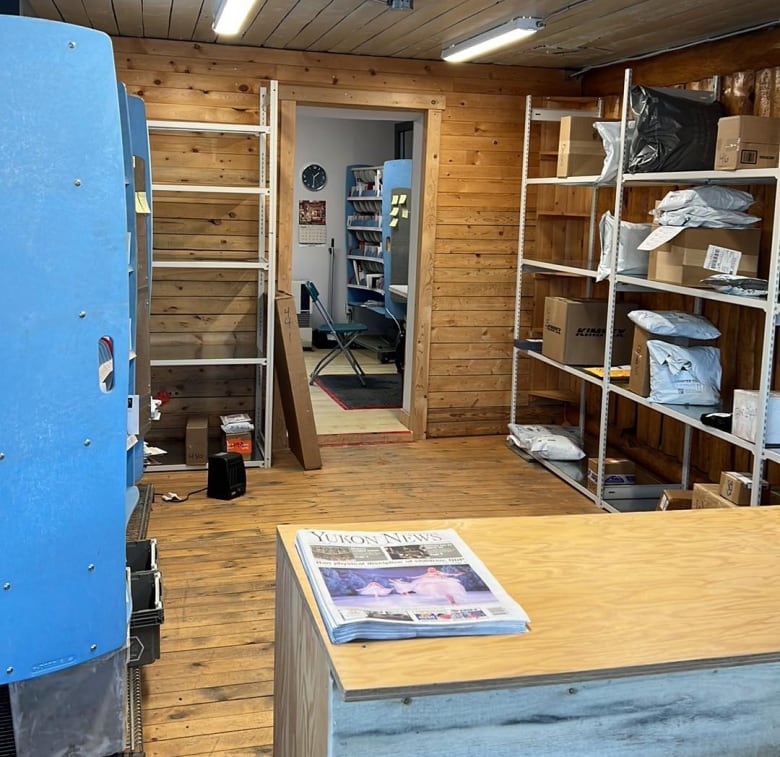 A small room with parcels stacked on a shelf.