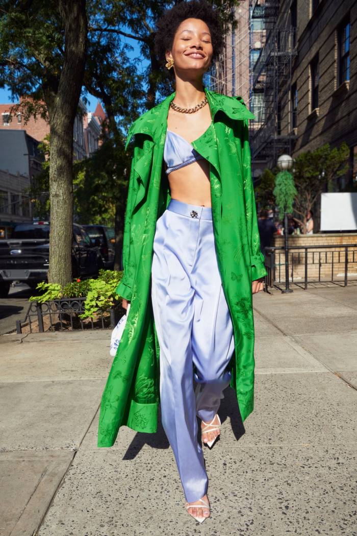 Woman in a blue suit and a long green coat