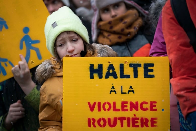 A child is holding a sign.