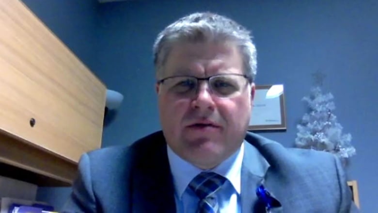 A portrait of a man sitting in an office.