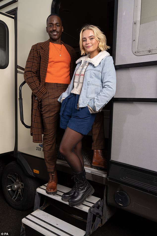 Different! The Sex Education star will sport a brown checked suit with an orange jumper, while Milly, who will play his companion Ruby Sunday, has donned a denim jacket and chunky boots