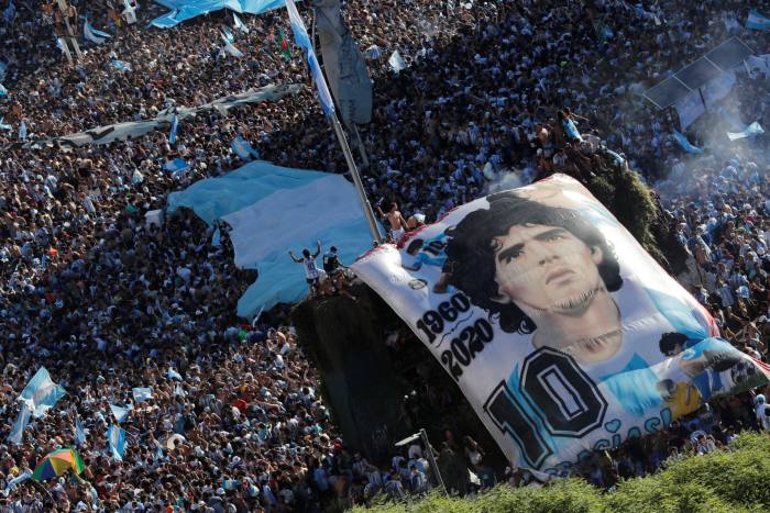 Argentina fans with a Diego Maradona banner celebrate their victory in Buenos Aires