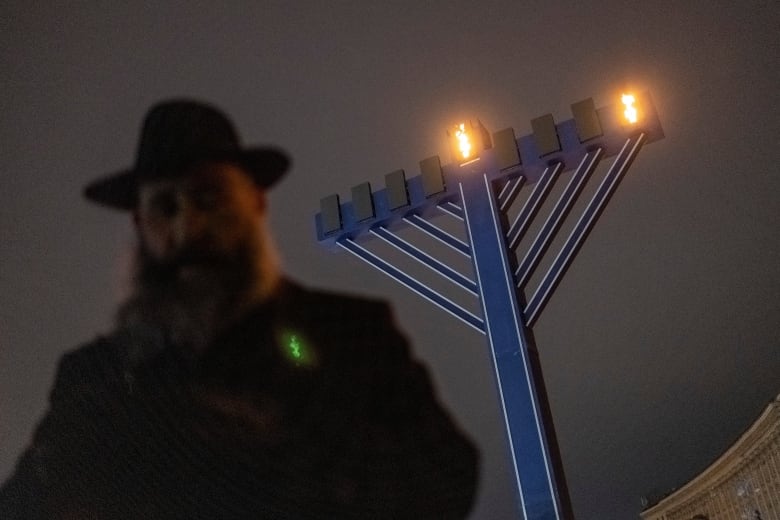 A giant menorah shines in the night sky in Kyiv.