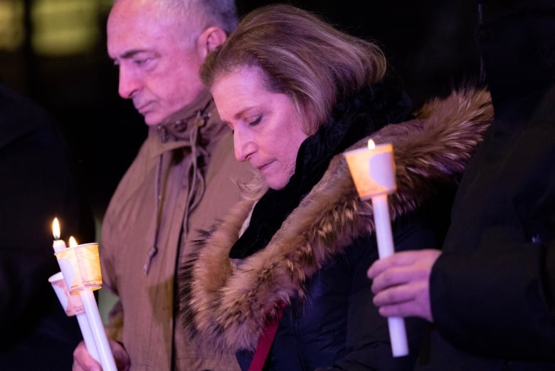 Members of the public attended a candlelight vigil for victims of a deadly condo shooting in Vaughan, Ont., on Wednesday, Dec. 21, 2022. 