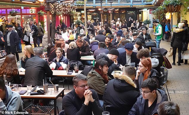 Beer gardens in Soho, London are packed to the rafters as people enjoy the start of the Christmas weekend