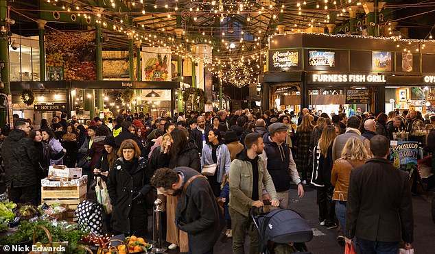 People pile into Borough Market in south London on the last working day before Christmas