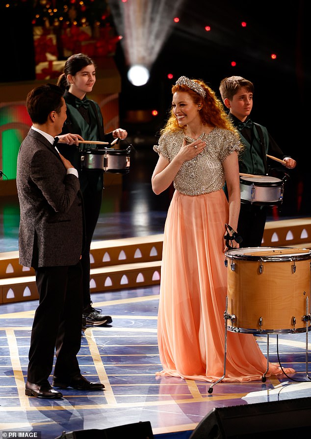 Former Wiggle Emma Watkins beamed as she took the stage in an etherial orange frock with silver beaded dealing on the bodice