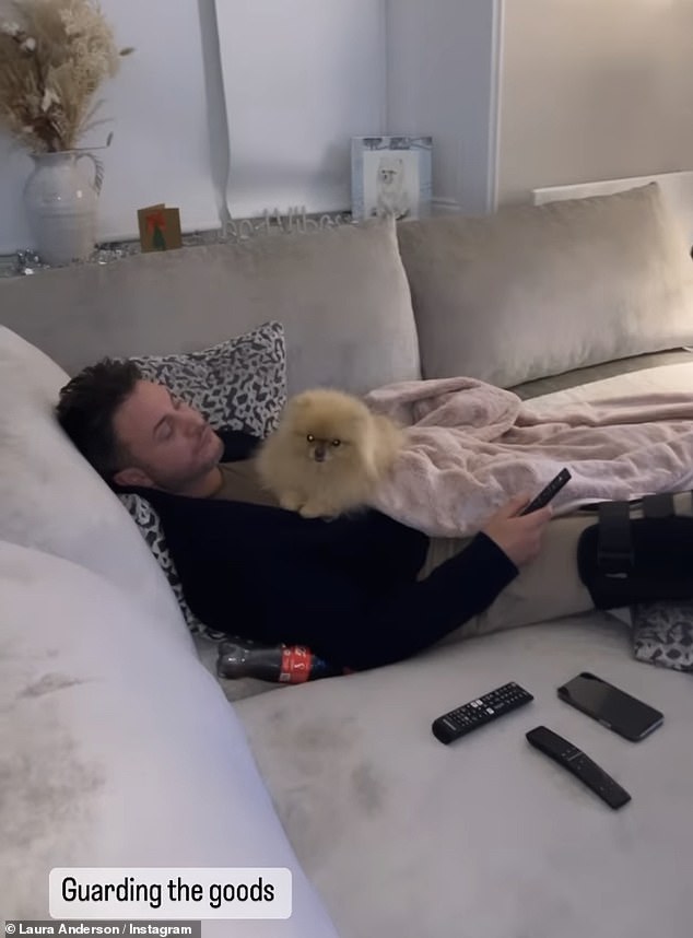 Down time: Gary ended the evening with some rest as he relaxed on the couch with Laura's dog Buddy, enjoying some TV