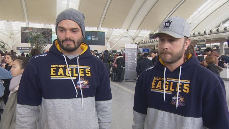 Two men stand side by side wearing Burlington Eagles-branded sports attire.