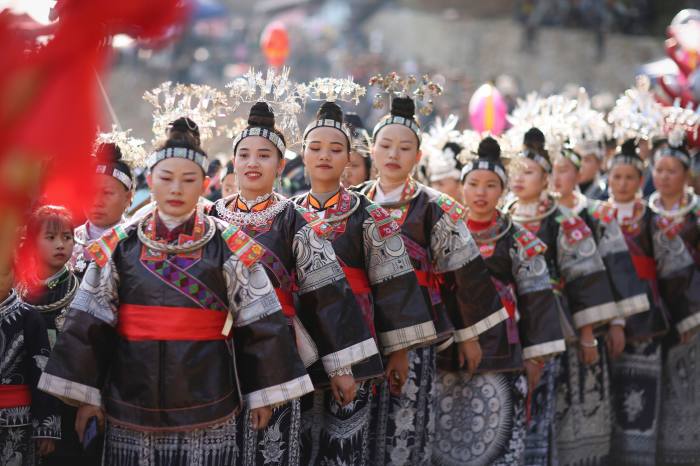 Girls from the Miao ethnic group dress up to attend the Chixin festival ceremony in Guizhou Province