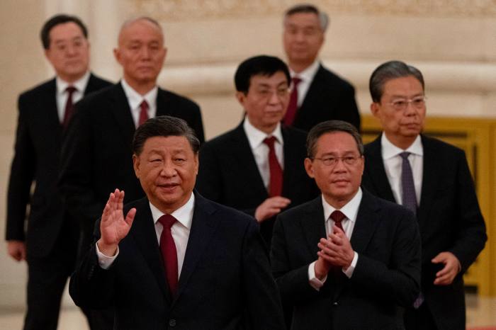 Politburo Standing Committee members Xi Jinping, Li Qiang, Zhao Leji, Wang Huning, Cai Qi, Ding Xuexiang and Li Xi arrive to meet the media in Beijing