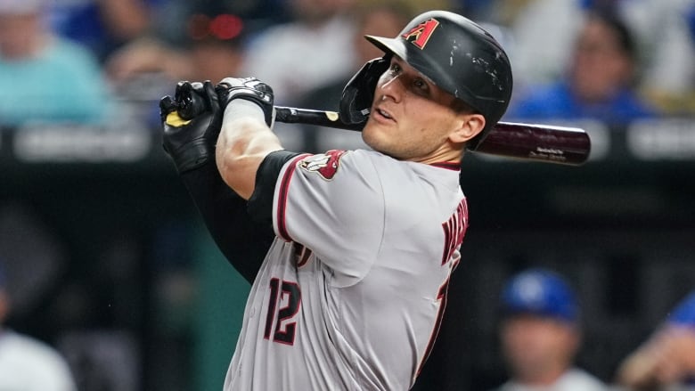 A batter looks up after connecting on a hit.