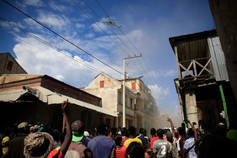 People protest against the arrival of the USNS Comfort hospital ship in Jeremie, Haiti, Tuesday, Dec. 13, 2022. The USNS Comfort is on a humanitarian mission to provide dental and medical services.