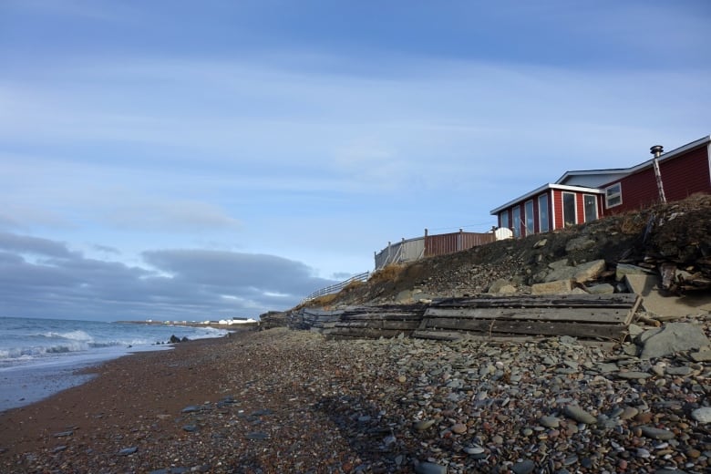 A house on a cliff just a few metres from the edge of the ocean.