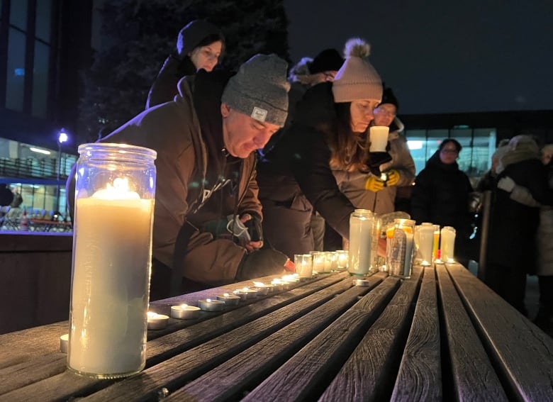 A candlelight vigil for victims of a shooting rampage drew more than 100 people on Wednesday night.