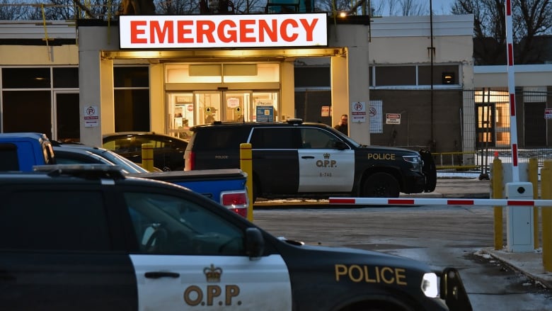 Police cars are seen outside an emergency department.