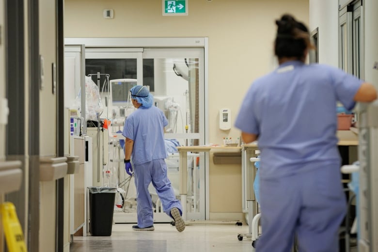 A nurse walks towards a patient in the emergency department of Humber River Hospital, in Toronto