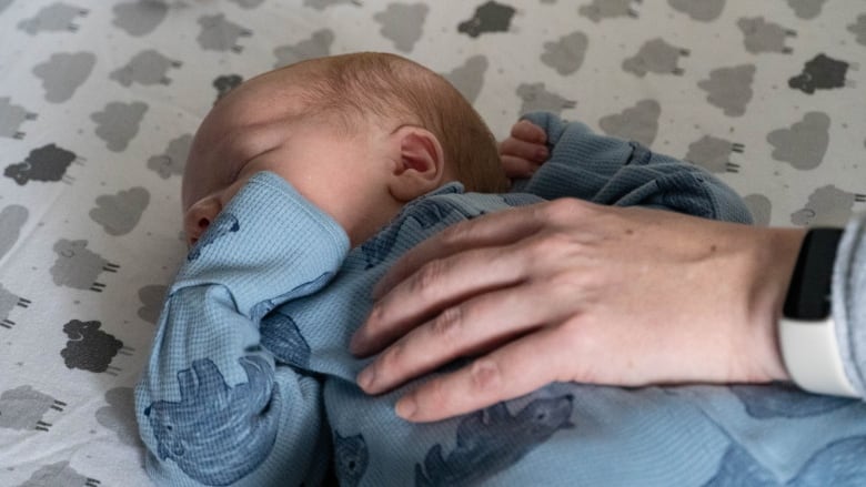 A baby in a crib.