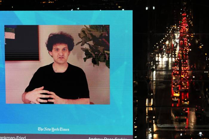 FTX founder Sam Bankman-Fried on a TV screen speaks during the New York Times DealBook Summit on Wednesday