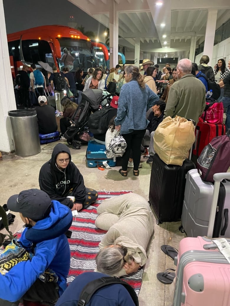 Passengers are seen as they await transport at the airport in Cancun, Mexico on Christmas Day. 