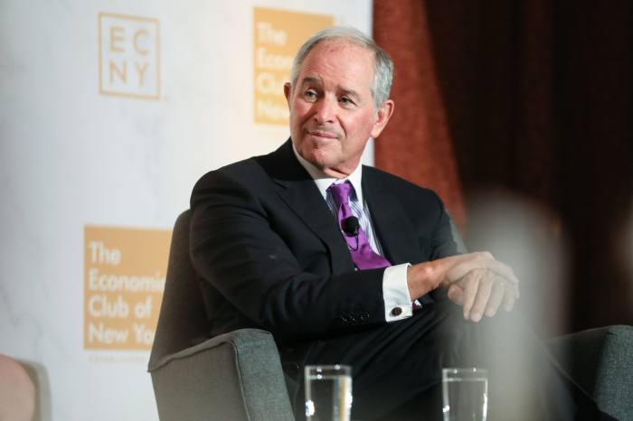 Stephen Schwarzman listens at an event