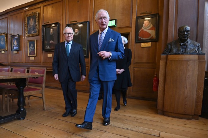 King Charles dressed in a suit and shiny black leather shoes