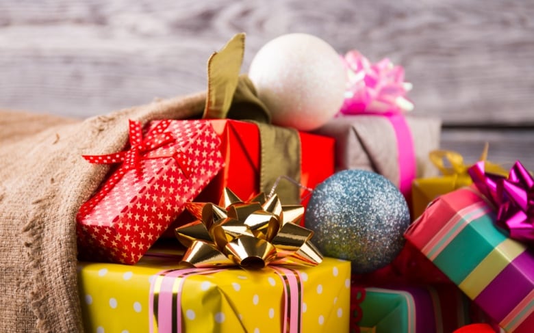 Close-up of gifts in wrapping paper and bows. 