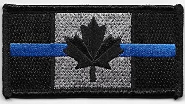 Vancouver city councillor defends wearing controversial thin blue line police patch