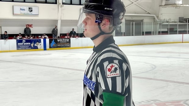 Young hockey officials wear green arm bands to reduce verbal abuse