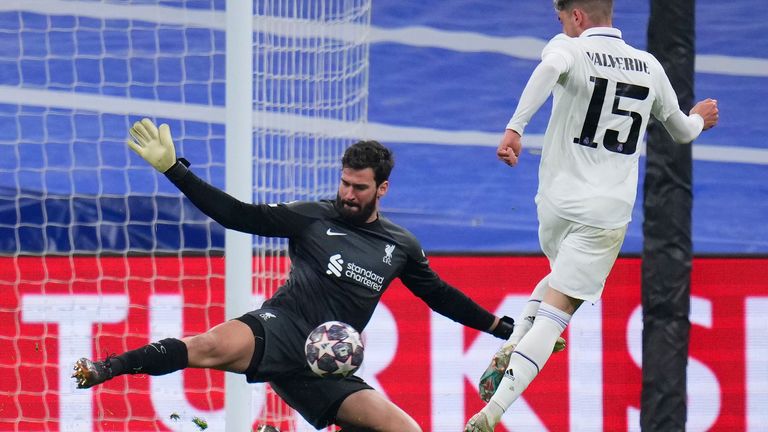 Real Madrid&#39;s Federico Valverde, right, tries to beat Liverpool&#39;s goalkeeper Alisson during the Champions League, round of 16 second leg soccer match between Real Madrid and Liverpool at the Santiago Bernabeu stadium in Wednesday, March 15, 2023. (AP Photo/Manu Fernandez)