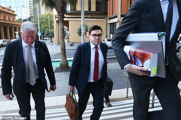 Bruce Lehrmann (pictured, centre, on Thursday) made up a version of what was happening in a meeting with his lawyer for the sake of his girlfriend, Greta Sinclair, the Federal Court heard