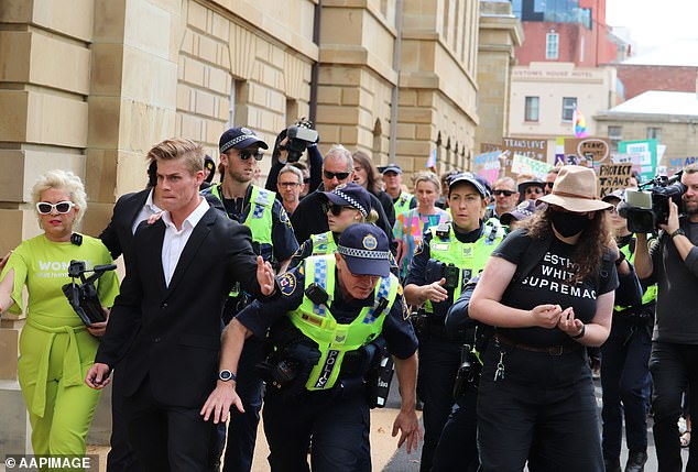 Ms Keen is seen arriving in Hobart on Tuesday with a bodyguard and police