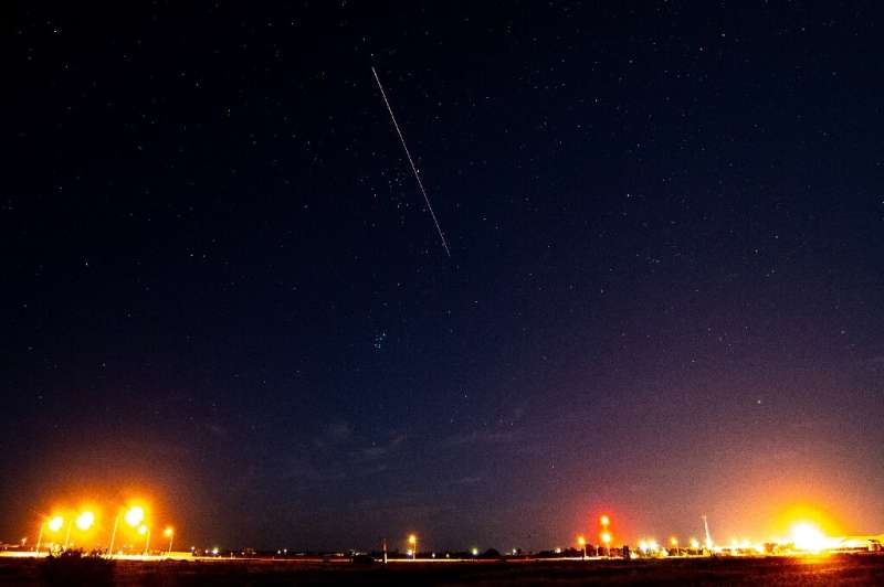 A long exposure shows the light trail of a re-entry capsule carrying samples from an asteroid on December 6, 2020