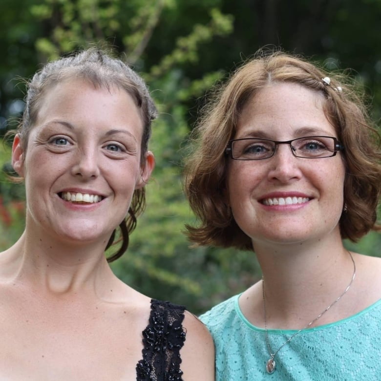 Two smiling women.  