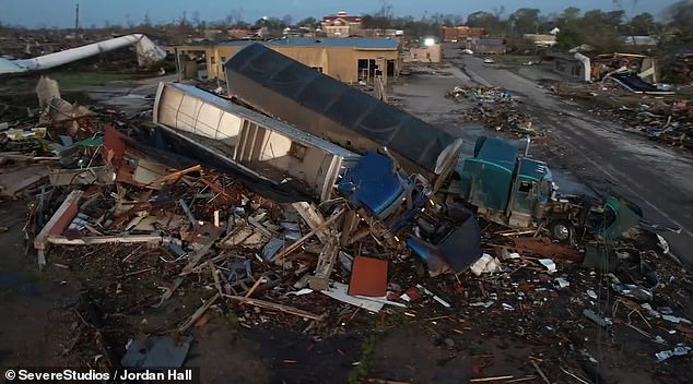 Two trucks were among the vehicles that were lodged among the debris