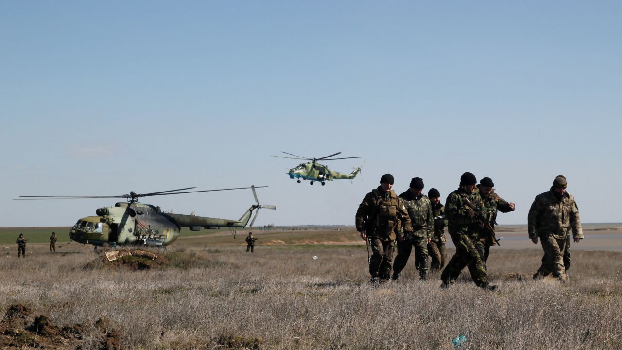 Ukrainian soldiers stand guard at a check point at the border between Ukraine and Crimea near the Salkovo village near Kherson, on March 18, 2014.