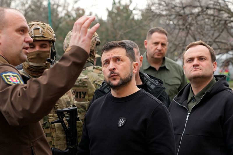 Ukraine's President Volodymyr Zelensky visits a missile-damaged area of Zaporizhzhia, Ukraine, Monday March 27, 2023.