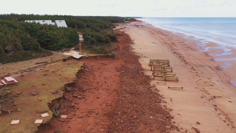 An overhead shot showing destruction on a red sand beach