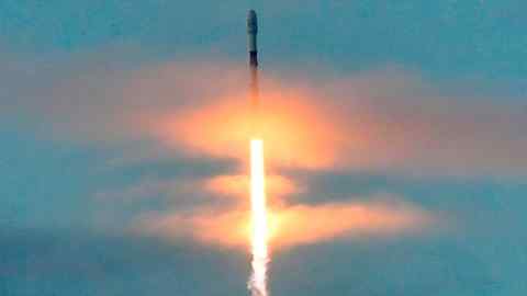 A SpaceX Falcon 9 rocket carrying 10 Iridium Communications satellites blasts off through clouds over Vandenberg Air Force Base near Lompoc, Calif.