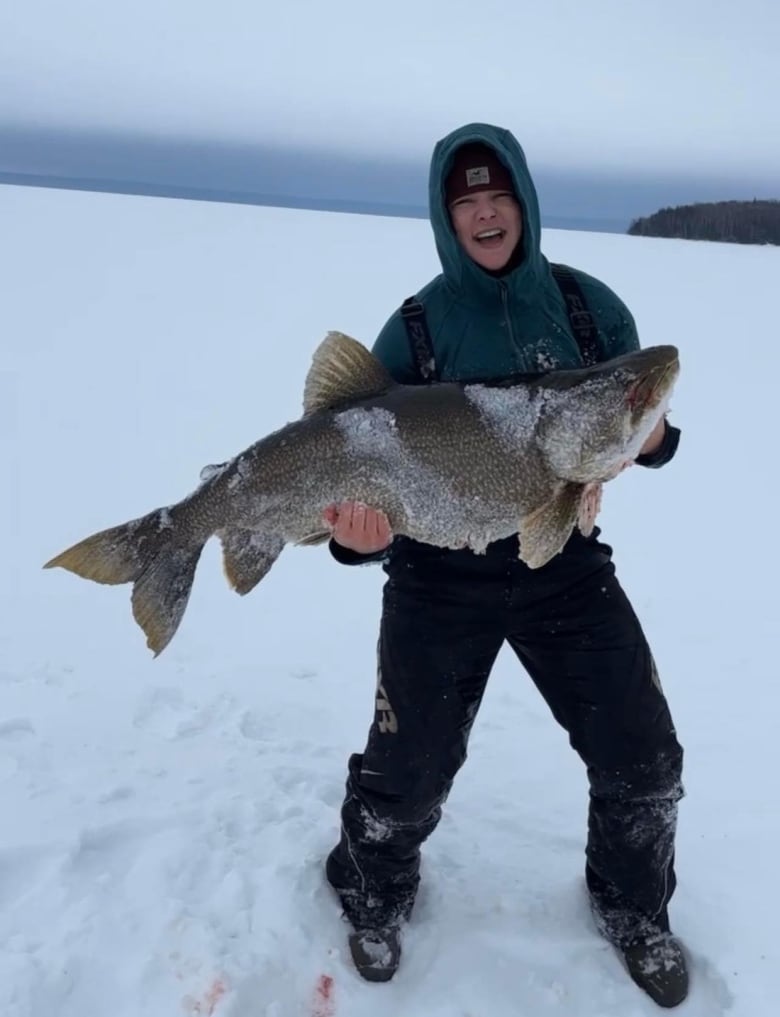 Sam Boucha holds a huge fish while out on the ice.