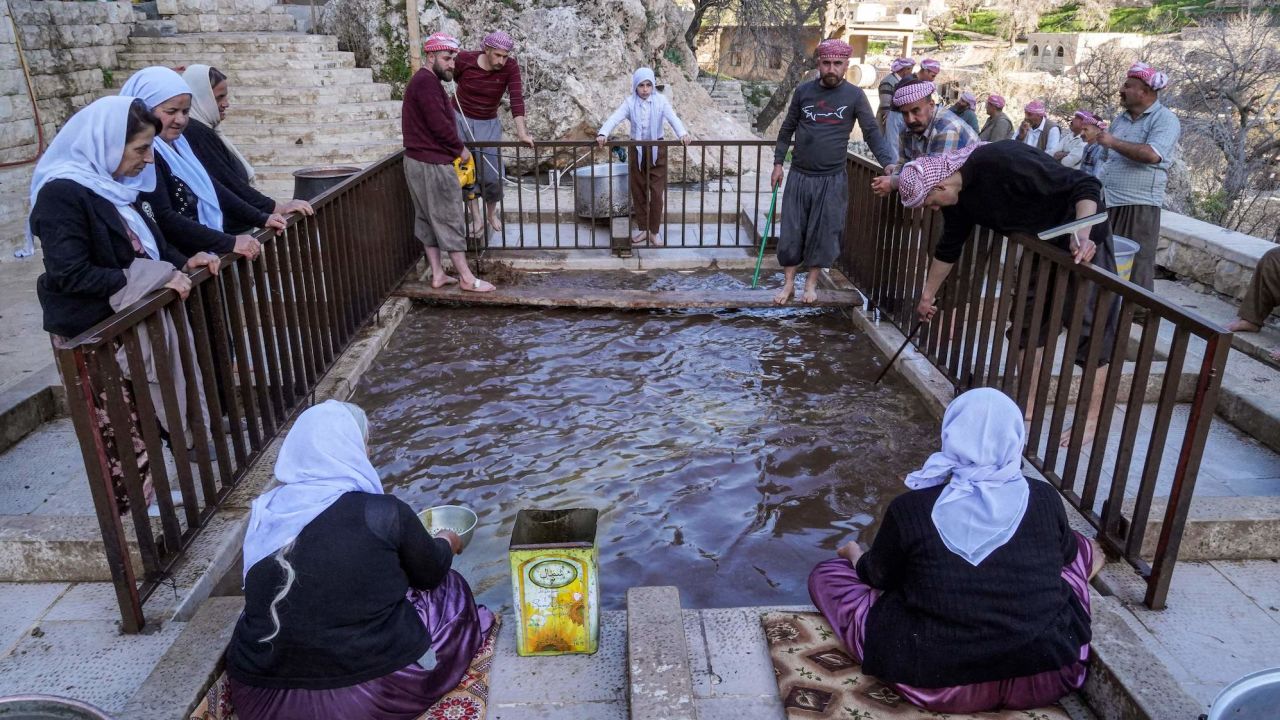 Yazidi devotees press olives during an annual religious tradition at the Lalish Temple in a valley near the Kurdish city of Dohuk in Iraq's autonomous Kurdistan region on Thursday.  