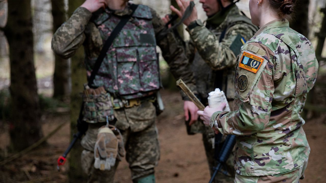 US Army Staff Sgt. Desirie Carson, a combat medic specialist assigned to Task Force Orion, 27th Infantry Brigade Combat Team, New York Army National Guard, instructs Armed Forces of Ukraine soldiers on how to apply a tourniquet during 