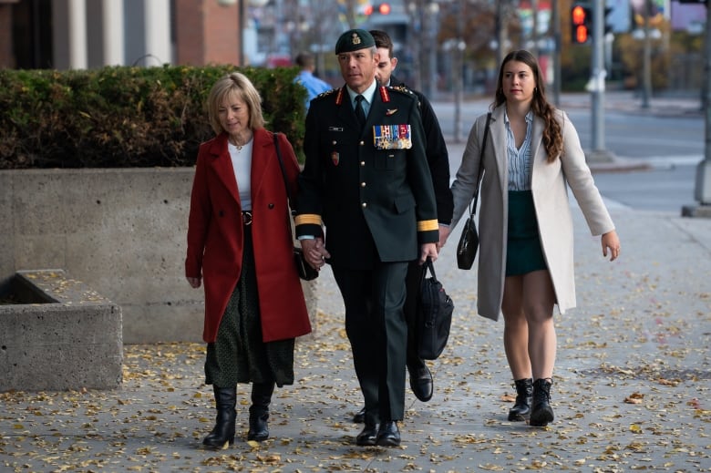 Photo of major general dany fortin walking into Quebec court with his wife and daughter during his criminal trial last year.